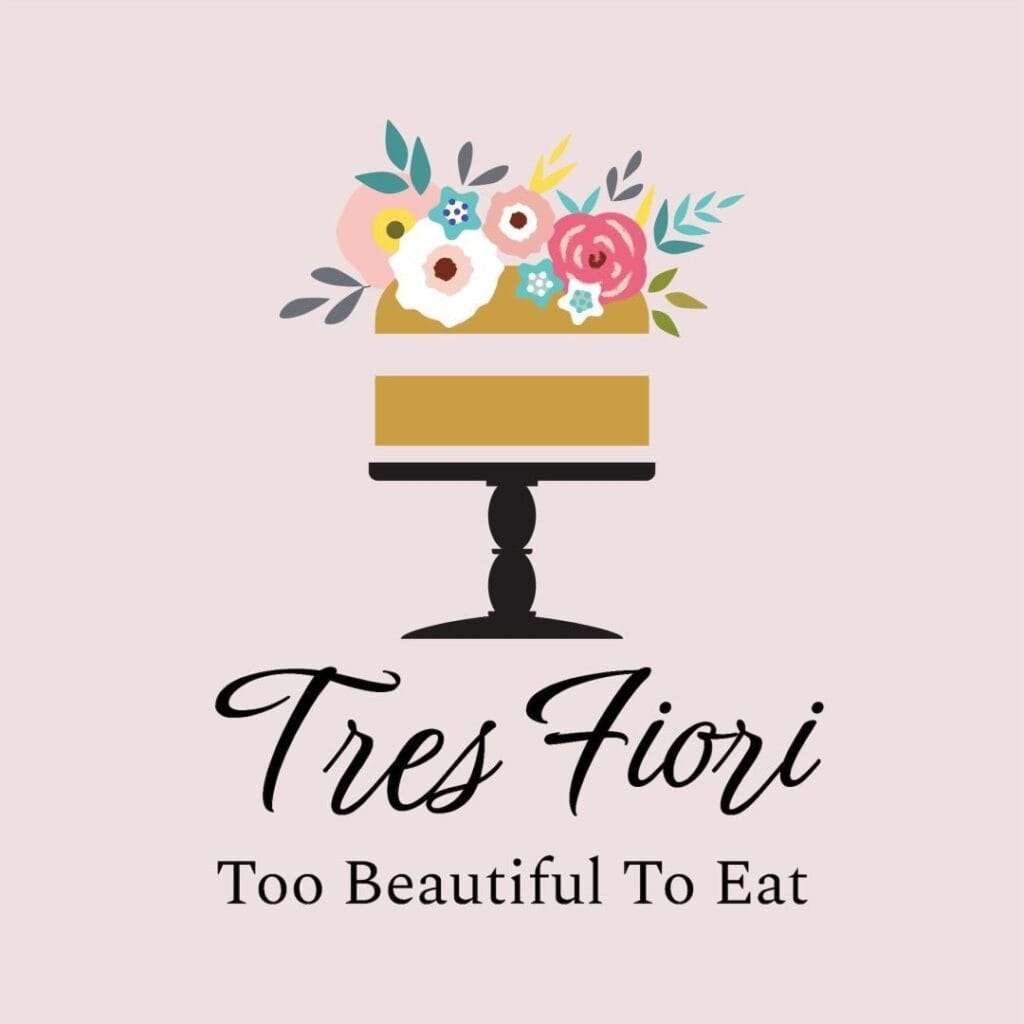 Cake with floral decoration on a stand, text "Tres Fiori: Too Beautiful To Eat" on a light pink background.